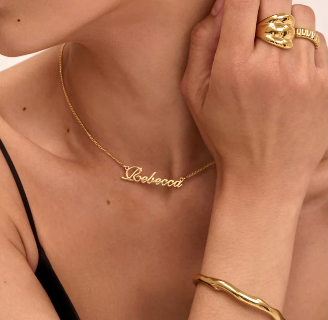 Collier prénom Signature ORAYA porté avec une tenue noire